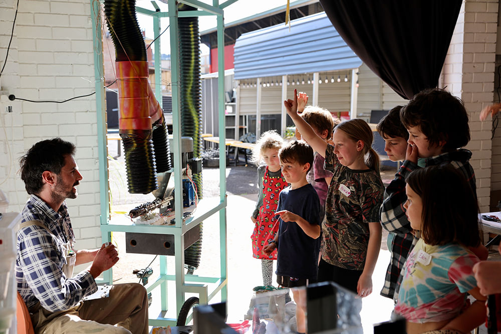 children listening to artist