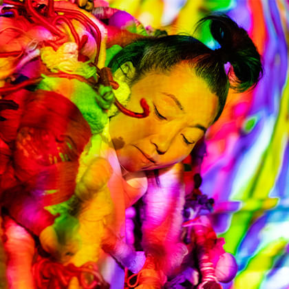 Hiromi Tango surrounded by colourful sculpture