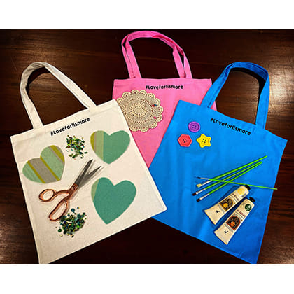 three decorated tote bags