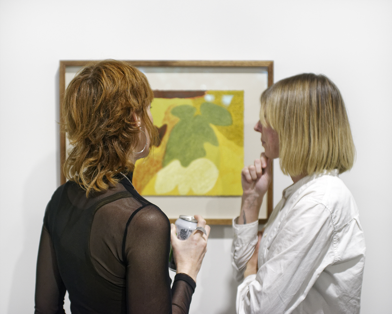 Two women looking at an artwork
