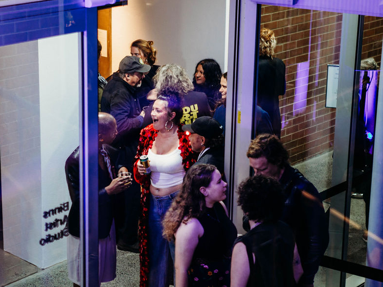 A group of people chatting during an exhibition opening