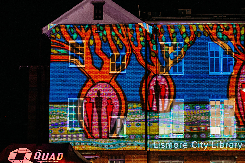 A projection of colourful boab trees on the Lismore Library