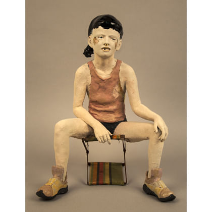 sculpture of a young person sitting on a stool