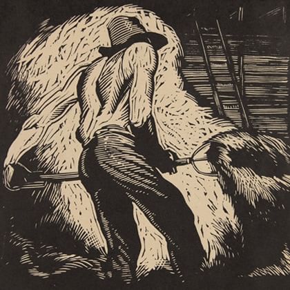 man moving hay with a fork