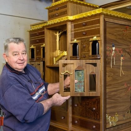 Geoff Hannah in front of cabinet he is making