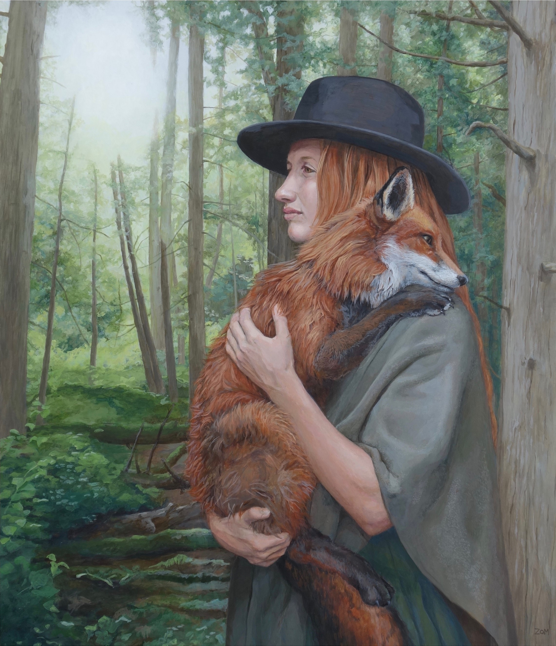 woman holding fox with lush forest background