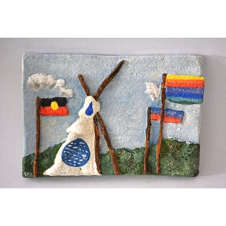 relief sculpture of a tent and flags including Aboriginal flag