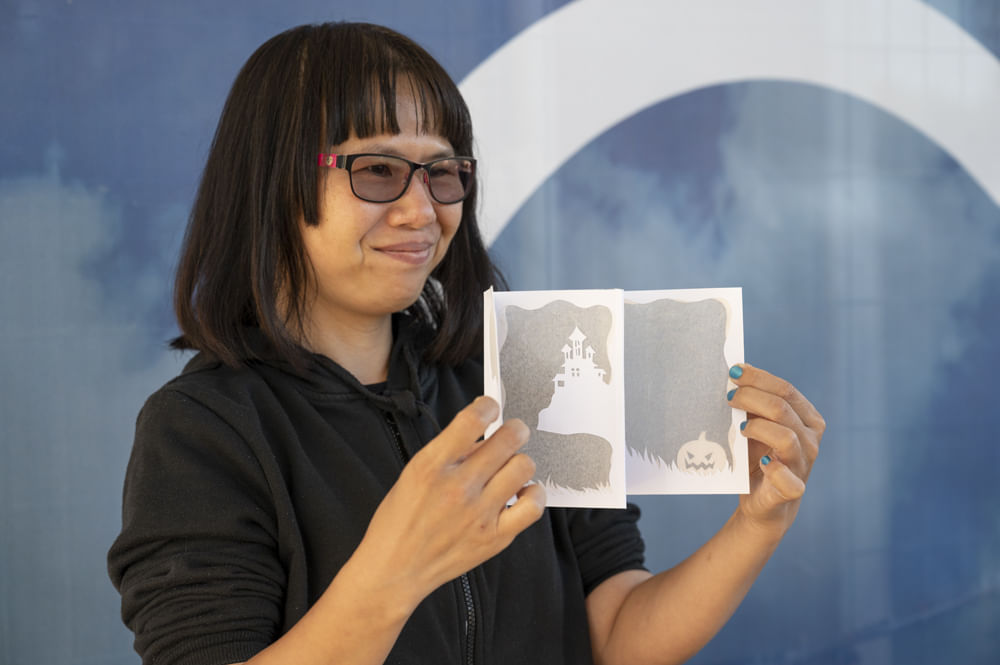 image of Hilda Wang holding a card