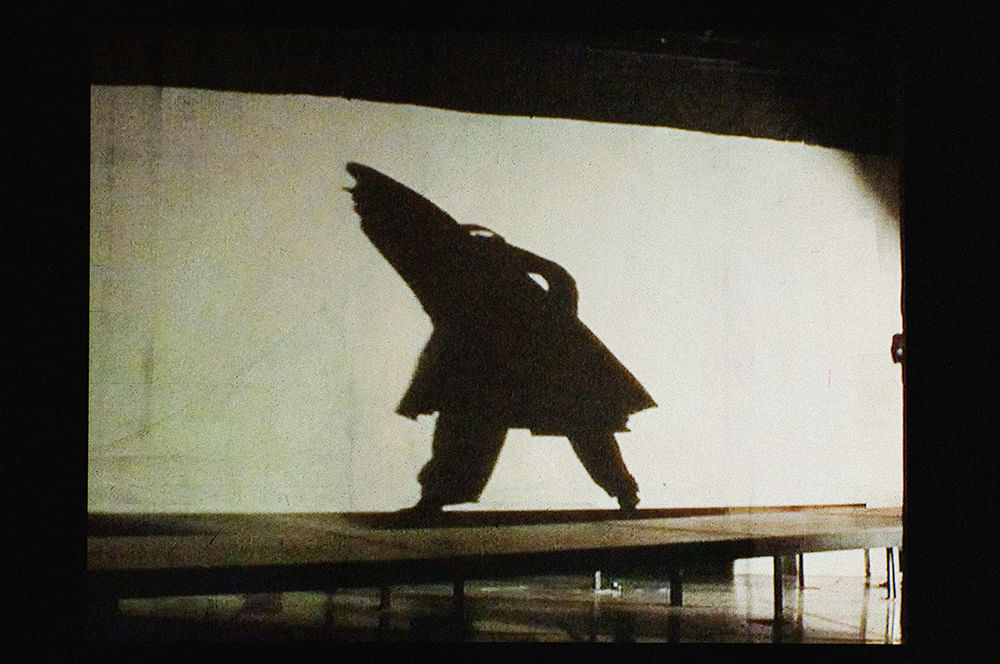 video still of person walking in hooded coat