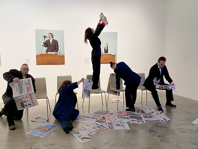 people reading  surrounded by newspapers