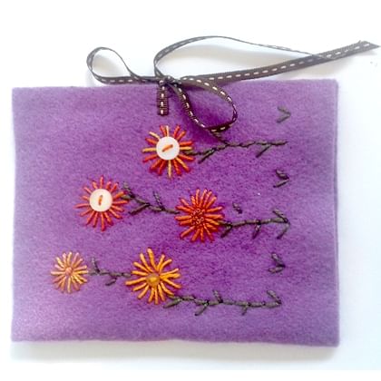 purple felt pouch embroidered with orange and gold flowers 