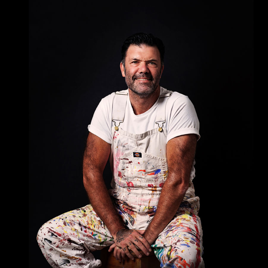 phto of Blak Douglas in paint splatters overalls