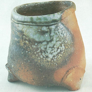 woodfired pot with green mottled glaze on part of it