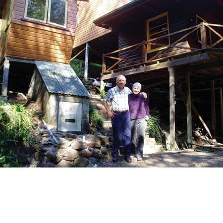 Leigh and Ellen Davison out the front of their owner built timber home 