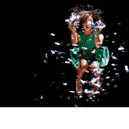 child on swing with small pieces of paper blowing around them 