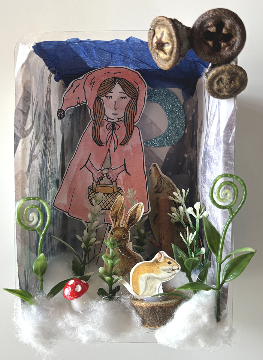 A 3D diorama depicting a forest scene, with a young girl carrying a basket, a squirrel, fox, rabbit, plants and a glittering cresent moon