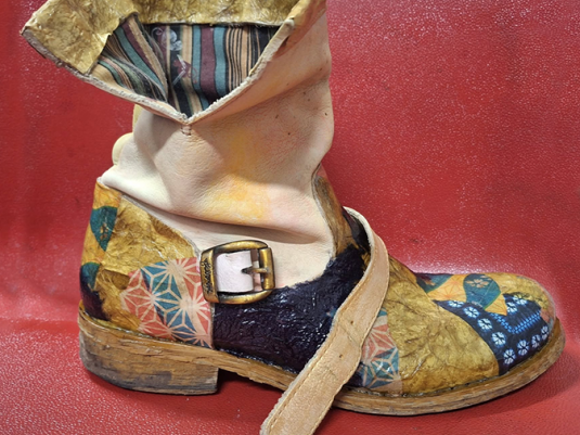 A boot that has been decoupaged