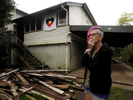 A first nations woman standing in front of her house in South Lismore, that was detroyed in the 2022 flood events.