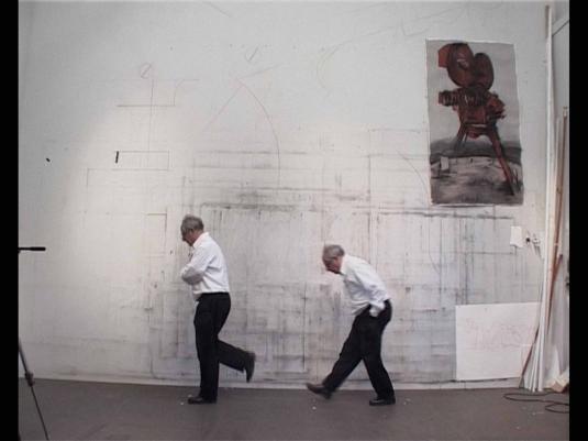 two men walking in front of a wall - image is of the same man in different walking positions.