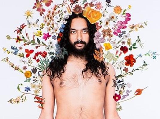 man surrounded by flowers