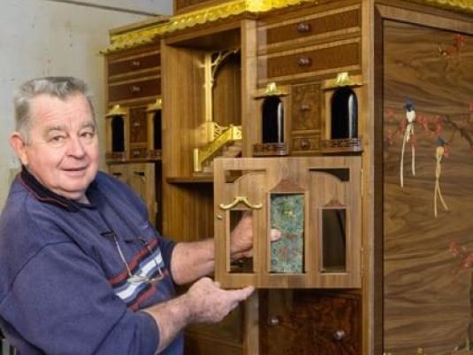 Geoff Hannah in front of cabinet he is making