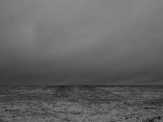image of storm clouds above treeless landscape