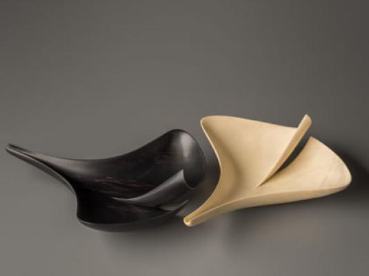 one black and one white forms in shape of ginkgo seeds