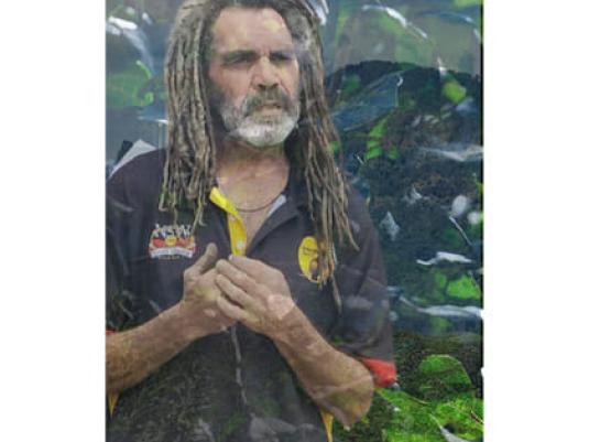 image of indigenous man surrounded by plants
