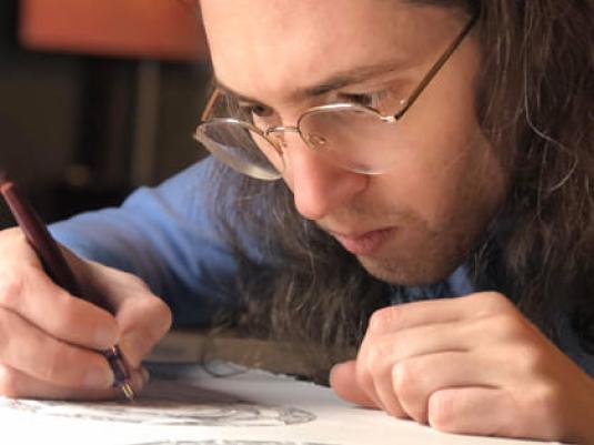 photo of Jack Stahel drawing with pen