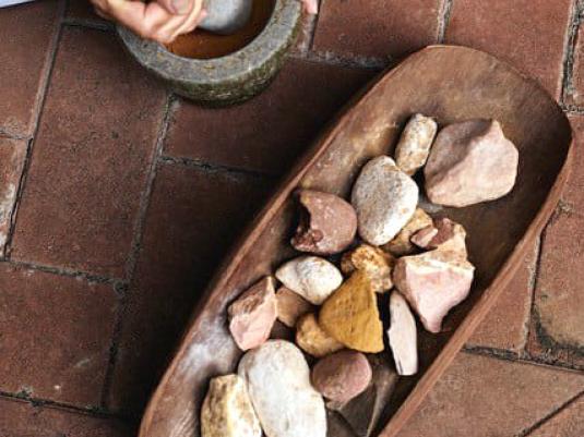 person grinding rocks to make ochre