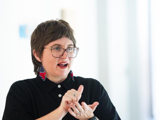 A woman signing in Auslan in a gallery