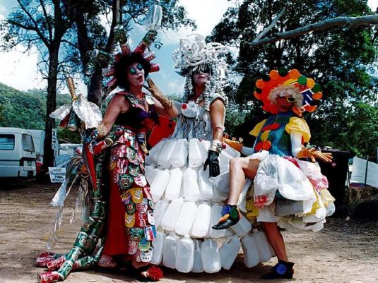 Three people wearing fabulous costumes of recycled materials