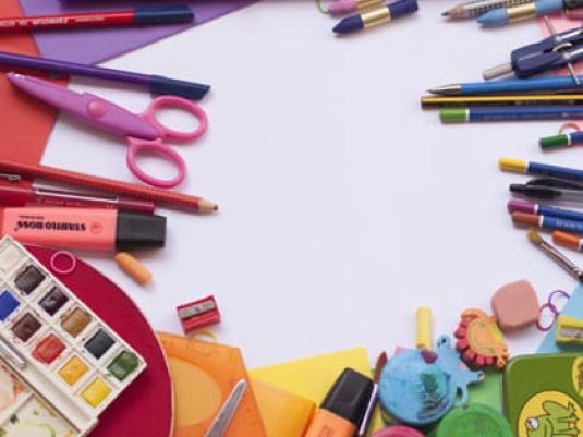 collection of art materials including pencils, paints, scissors, markers and stamps