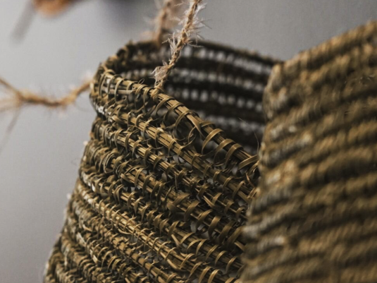 Two woven baskets hanging on a wall