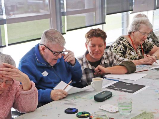 A group of seniors enjoying an art activity