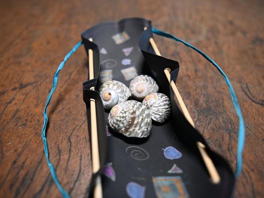 A photo of a completed water carrier with shells inside.
